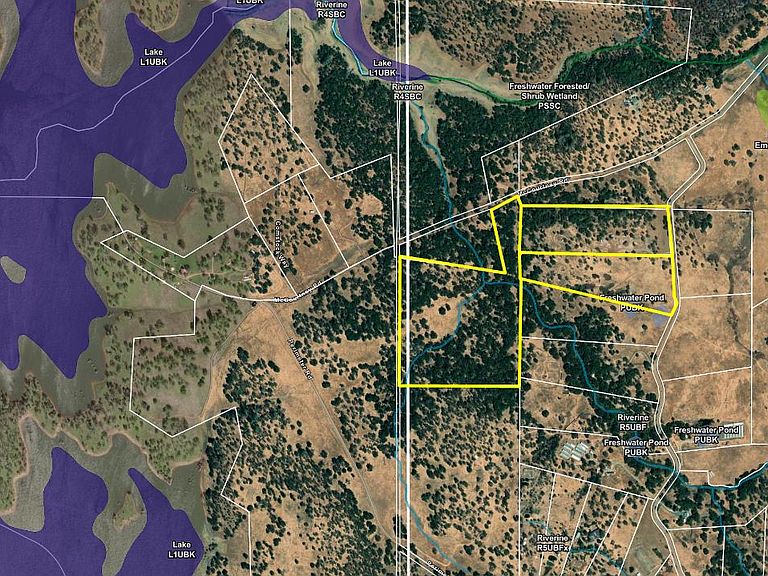USGS-style aerial survey map showing three contiguous parcels outlined in yellow against the topography of Grass Valley, with Camp Far West Lake on the western edge of the frame